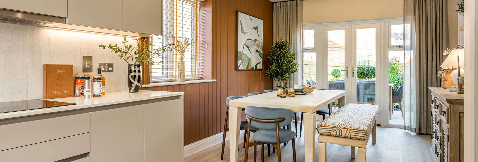 Contemporary designed kitchen with dining table leading out to garden via patio doors