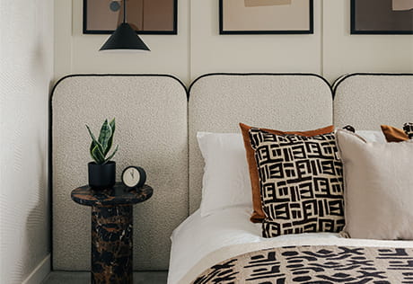 Modern designed bed, decorated in cream-white, mosaic pattern, wall hangings