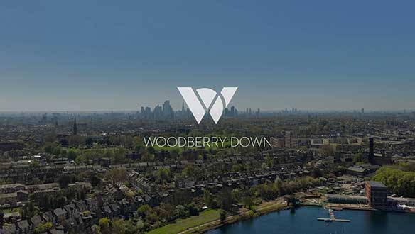 Video placeholder thumbnail with Woodberry Down Logo with the development surroundings as a backdrop.