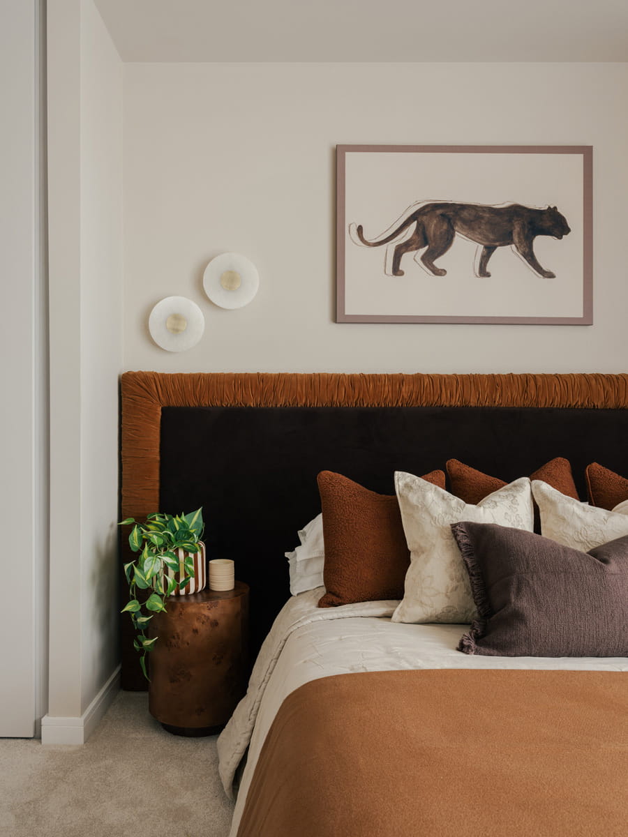 Bedside with table, wall hanging, black and dark orange headboard