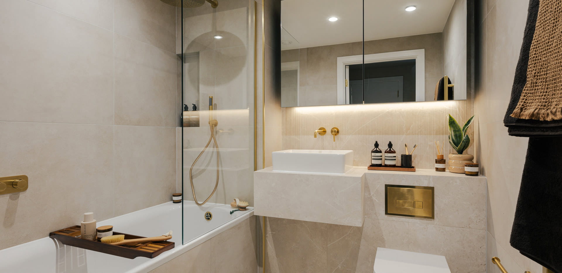 Modern bathroom with shower over bath, wash basin with cabinet mirrors