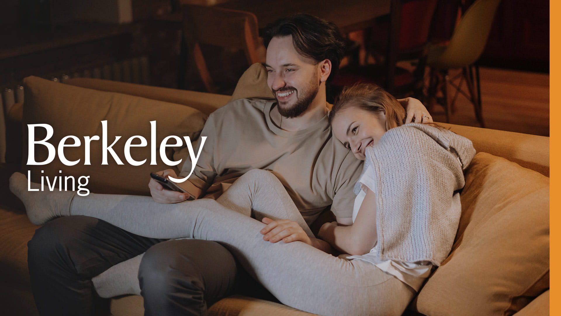 An image of a couple laughing on the sofa with the Berkeley Living logo overlaid