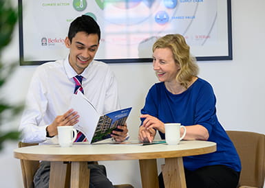 Picture of graduate and mentor laughing together