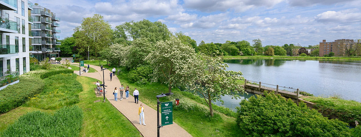Exterior image of residents enjoying a walk by a lake