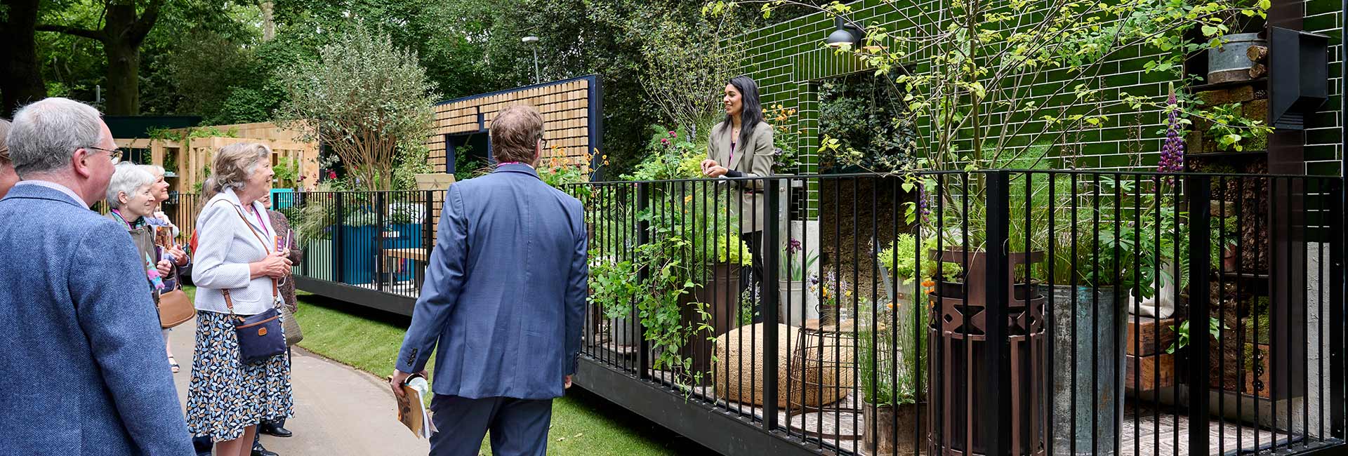 People gathering round plants at the flower show