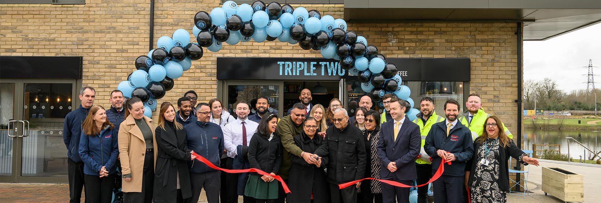 News and Insights - People celebrating the opening of Triple Two Coffee Shop