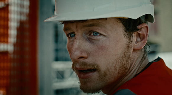 An image of a construction worker suffering from slavery in the workplace