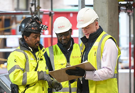 An image of people in PPE talking on a construction site