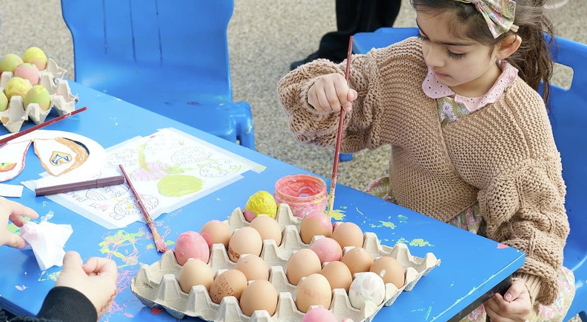 An image of children painting eggs at an Easter Event at The Green Quarter