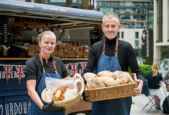 An image of sourdough suppliers posing in front of their baked goods van