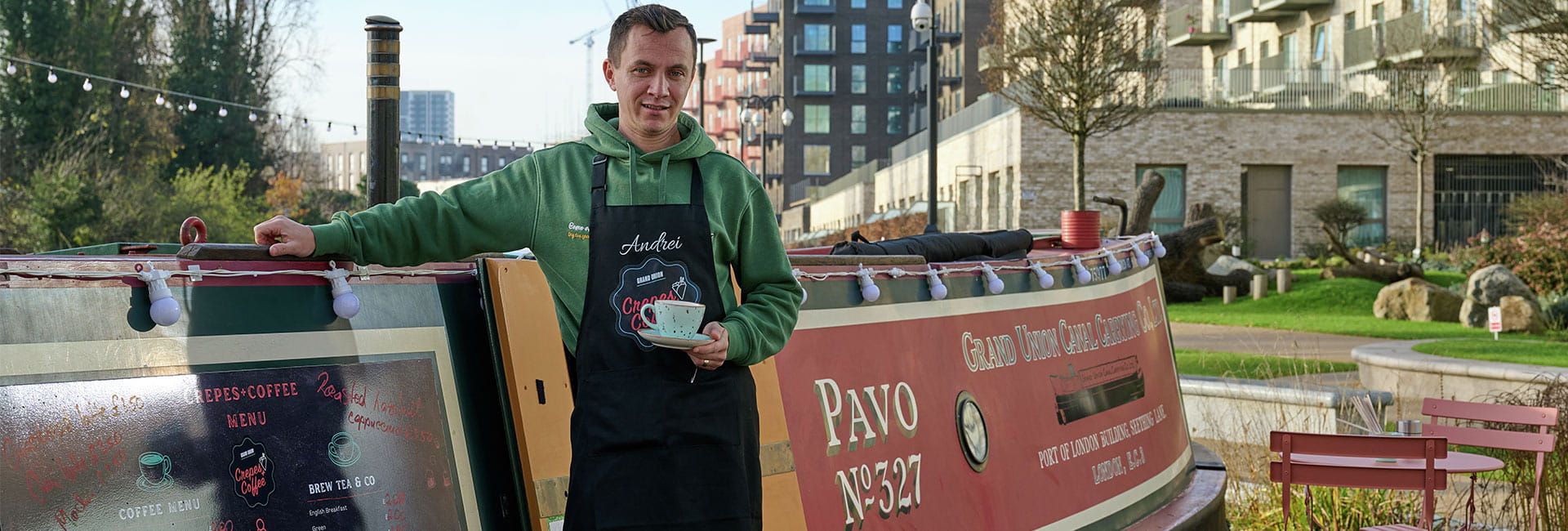 An image of Andrei standing outside his narrowboat shop