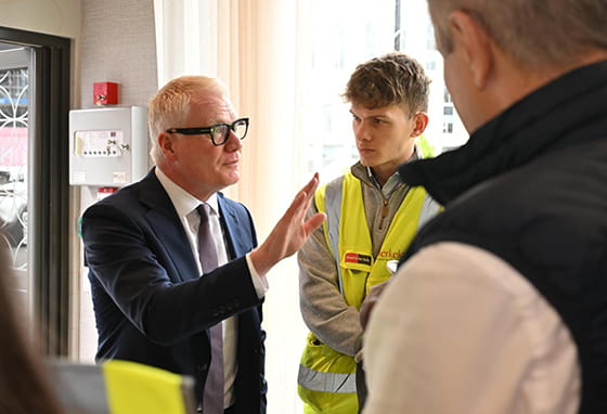 An image of someone giving a speech to the people at Glasswater Locks