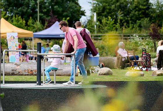 An image of a father playing with his child at the Picnic in the Park event