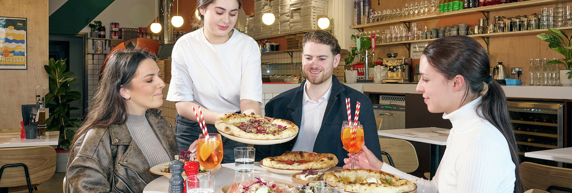Image of customers enjoying Pizza