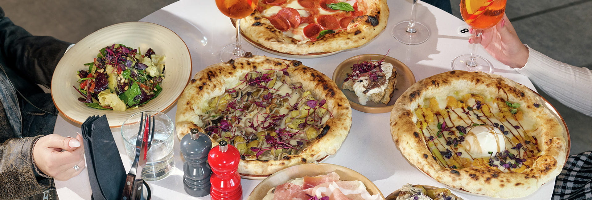 Image of customers enjoying Pizza