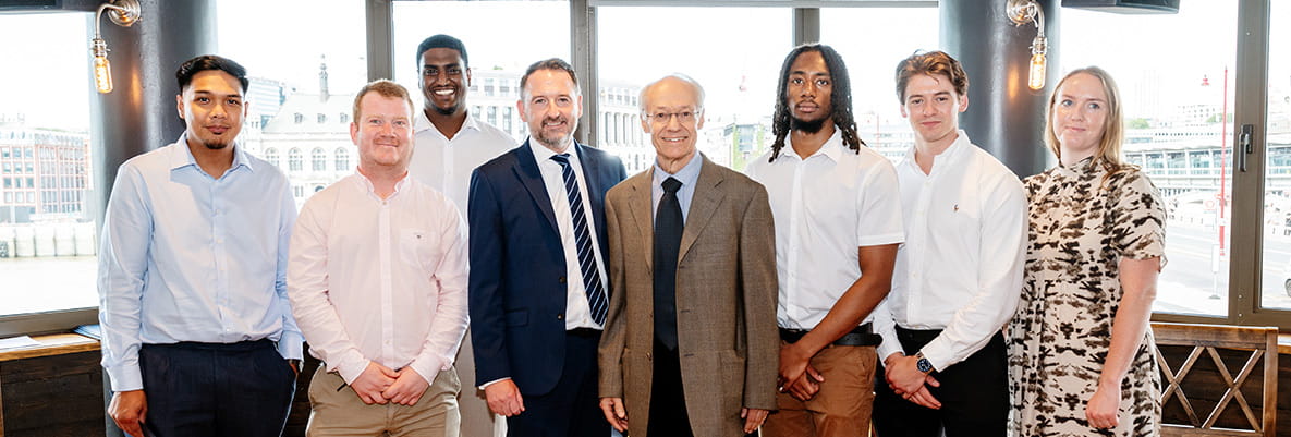 An image of some apprentices standing with their tutor
