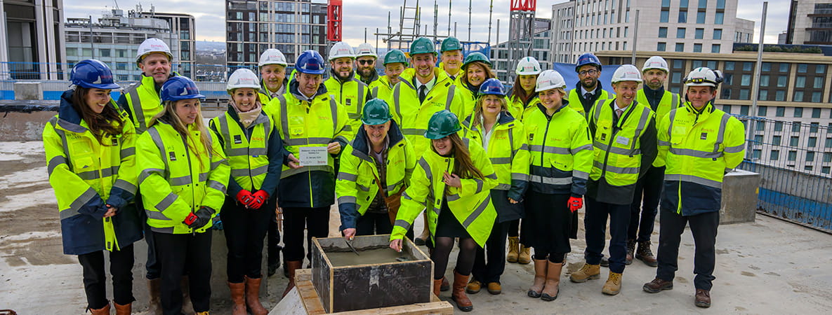 An image of people on top of a construction building