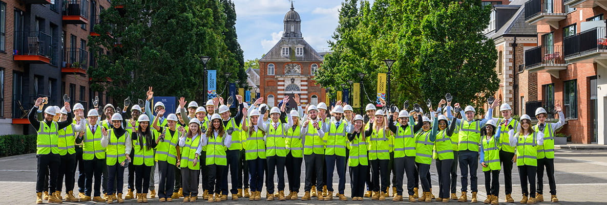 Members of the 5% Club posing for a group photo at Royal Arsenal Riverside