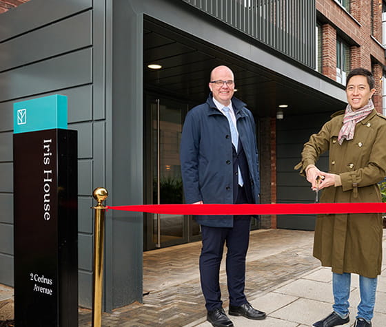 An image of people outside Iris House for the Ribbon to be cut