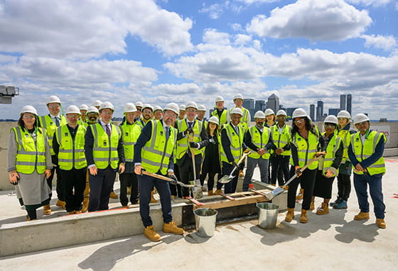 St James staff posing for a photo topping out at Bow Green