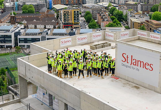 St James staff posing for a photo topping out at Bow Green