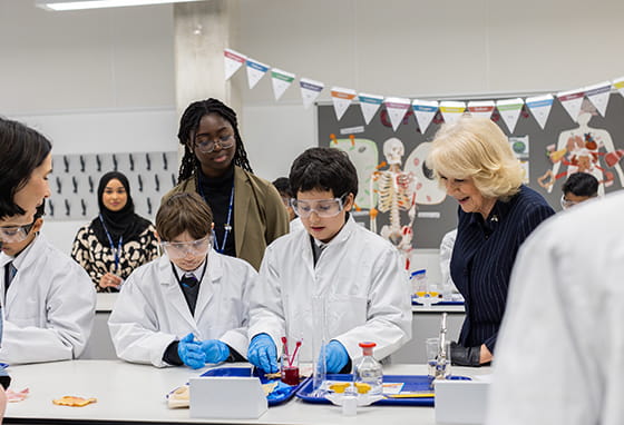 Her Majesty The Queen spectating a science lesson at Mulberry Academy