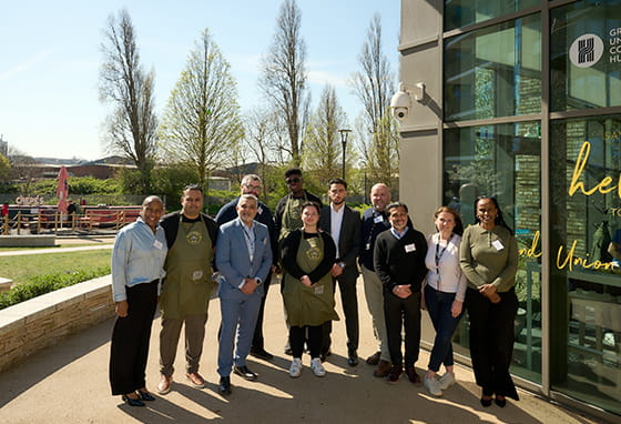 Grand Union team group photo outside of the new school 