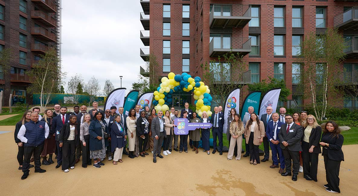 An exterior image of Grand Union with People Celebrating The Launch of the 115 New Homes for Brent Council