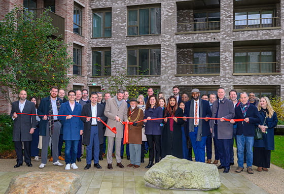 An image of all people attending the unveiling of the affordable homes at Oval Village