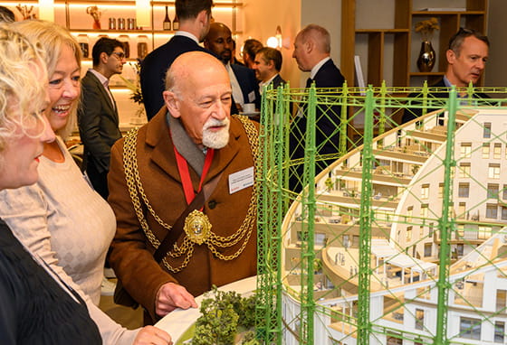 An image of people looking at the development building in the sales suite
