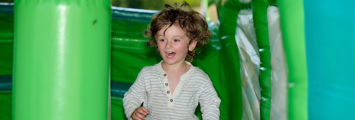 An image of a child on the bouncy castle at Highcrofts Picnic at the Park
