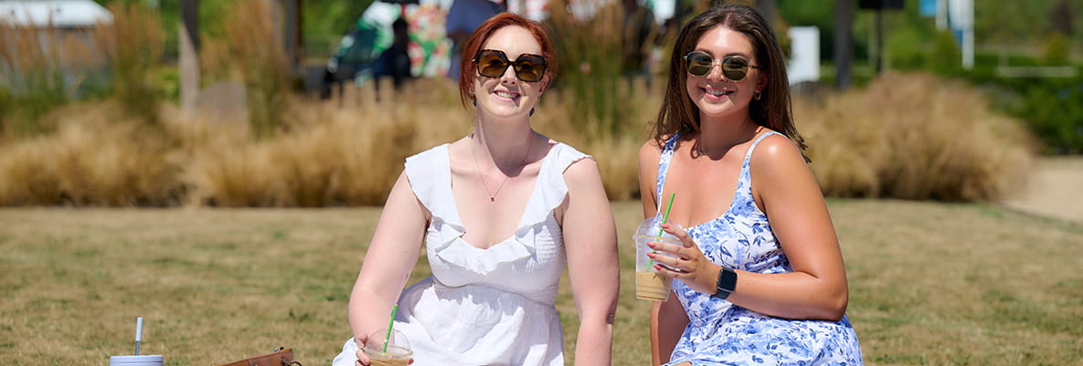 An image of people sat enjoying the sun at Highcrofts Picnic at the Park