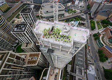 An image of St James workers and partners at White City Living at the top of The Solaris building