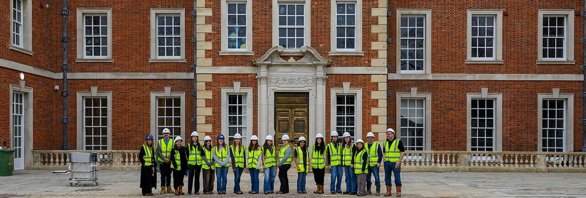 An image of people outside a Berkeley development in PPE who are visiting