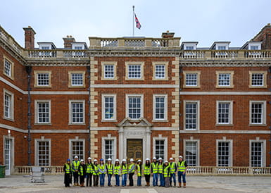 An image of people outside a Berkeley development in PPE who are visiting