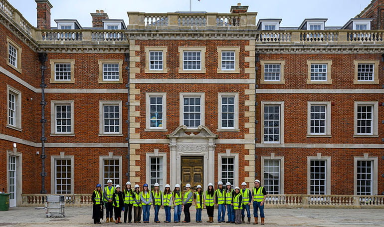 An image of people outside a Berkeley development in PPE who are visiting