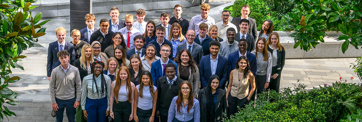 An image of apprentices standing together in a courtyard