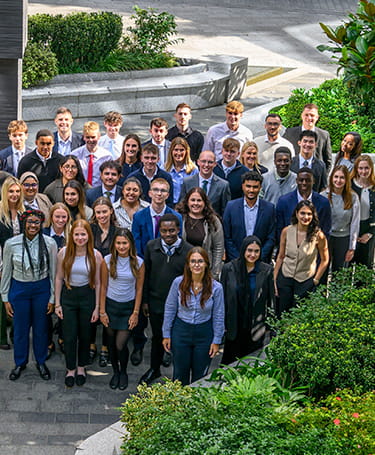 An image of apprentices standing together in a courtyard