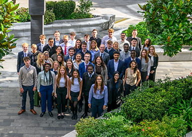 An image of apprentices standing together in a courtyard