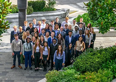 An image of apprentices standing together in a courtyard