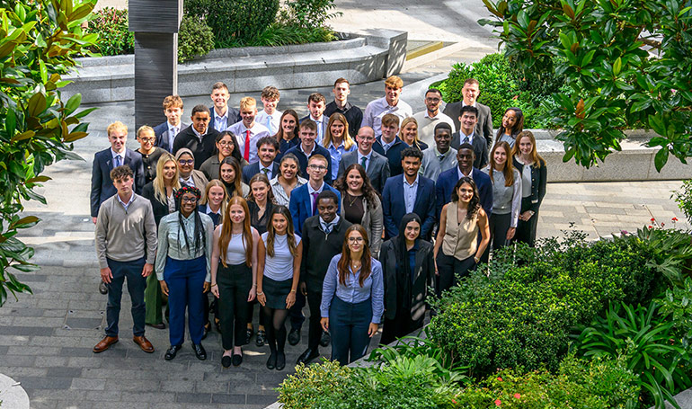 An image of apprentices standing together in a courtyard
