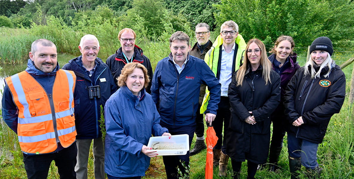 Group photo of representatives from Milton Keynes Council, conservation groups at Great Linford Nature Reserve.