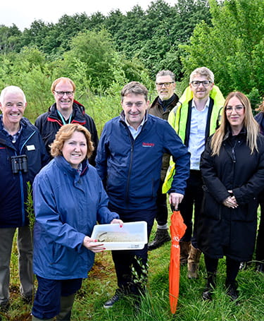 Group photo of representatives from Milton Keynes Council, conservation groups at Great Linford Nature Reserve.