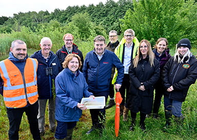 Group photo of representatives from Milton Keynes Council, conservation groups at Great Linford Nature Reserve.