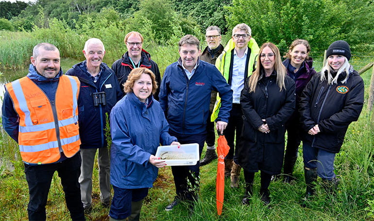 Group photo of representatives from Milton Keynes Council, conservation groups at Great Linford Nature Reserve.