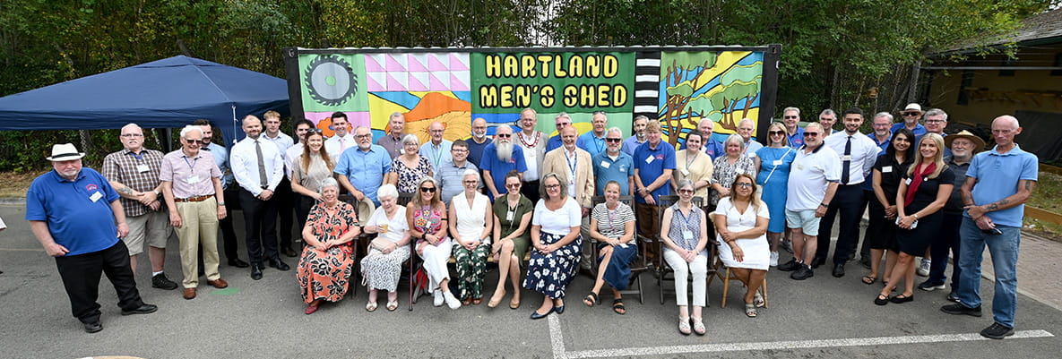 An image of people at the Men's Shed at Hartland Village