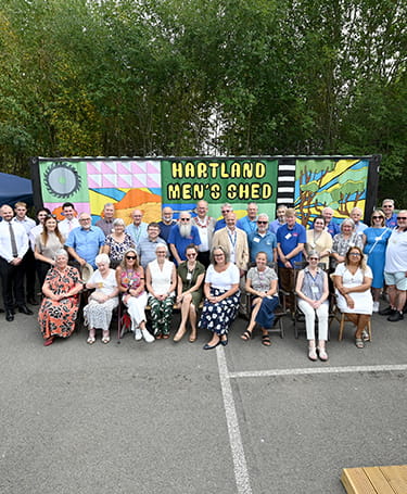 An image of people at the Men's Shed at Hartland Village