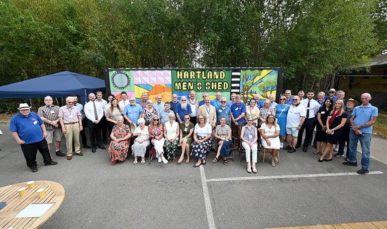 An image of people at the Men's Shed at Hartland Village